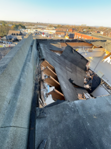Severe storm damage to a commercial roof assessed by New World Structural Solutions